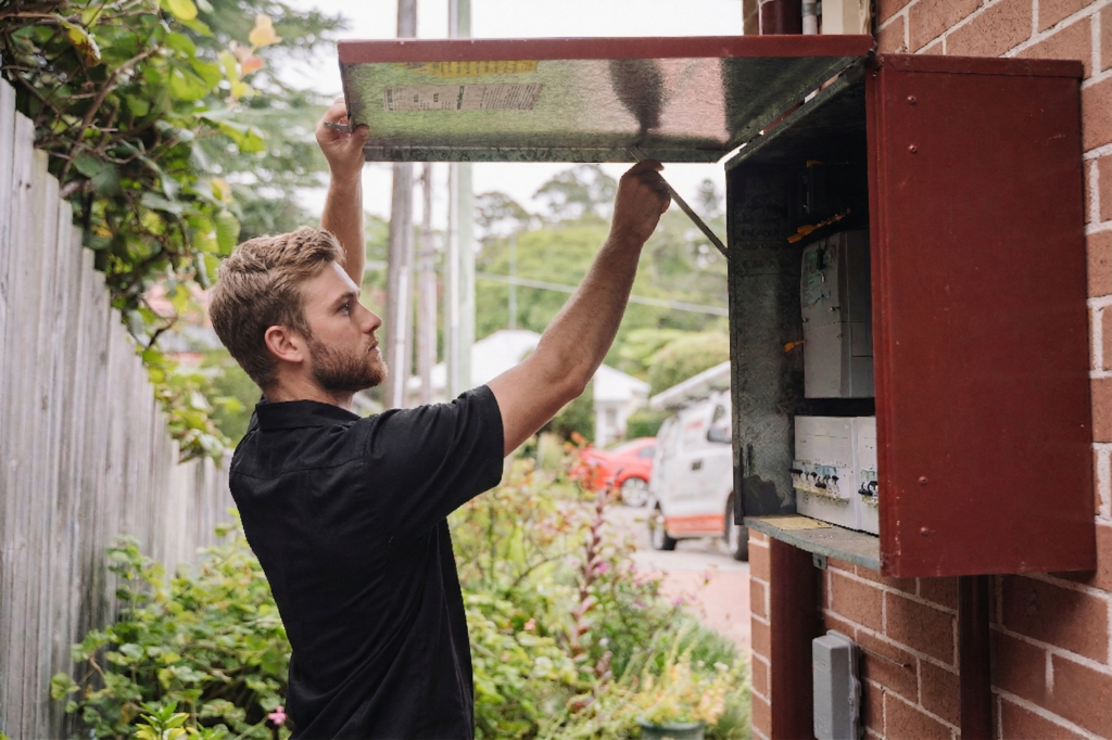 Electrician installing downlights in a Summer Hill home